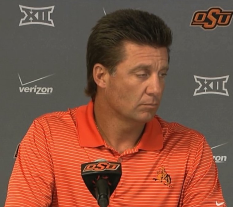a photo of Mike Gundy looking despondent